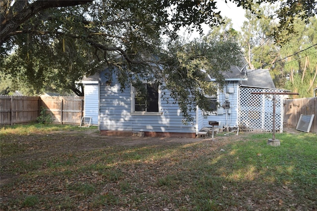 back of property with a lawn