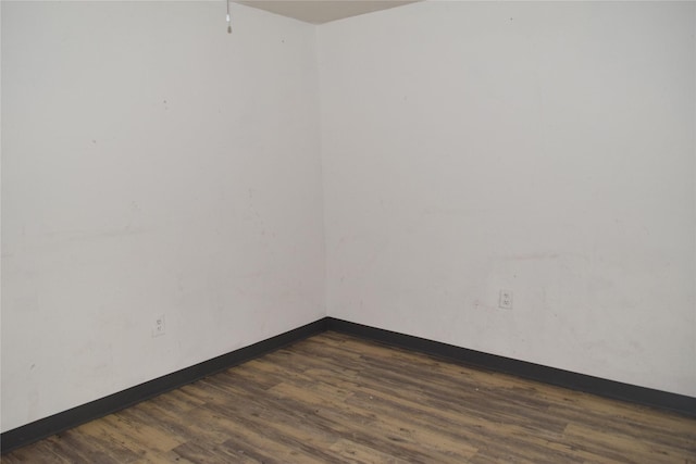 unfurnished room featuring dark hardwood / wood-style floors