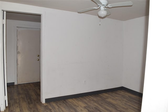 empty room with ceiling fan and dark hardwood / wood-style flooring