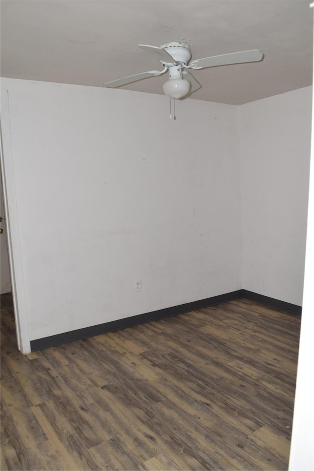 empty room featuring ceiling fan and dark hardwood / wood-style flooring