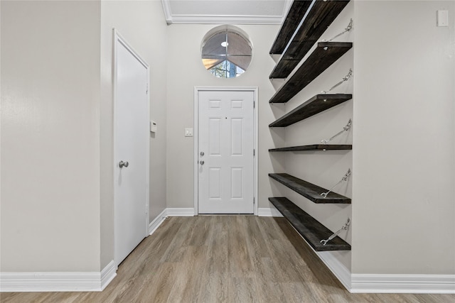 foyer with light wood-style flooring and baseboards