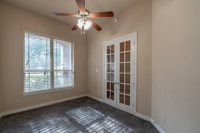 spare room with french doors, ceiling fan, and dark colored carpet