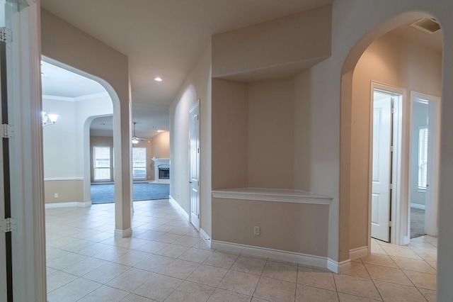 interior space featuring crown molding and ceiling fan