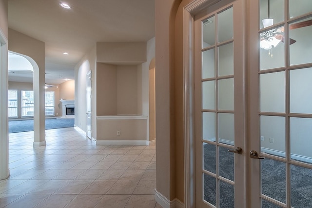 hall with light tile patterned floors and french doors