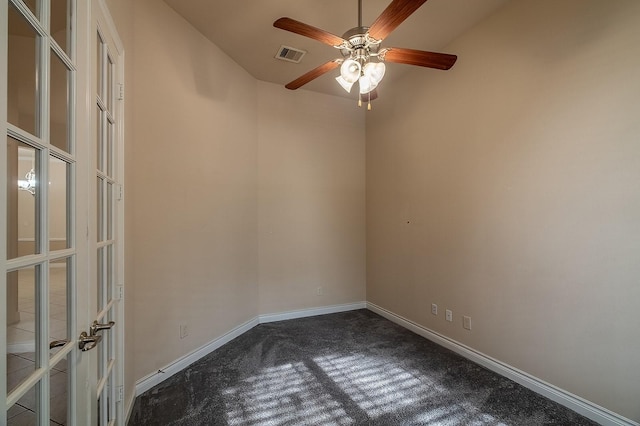 carpeted spare room with ceiling fan and french doors