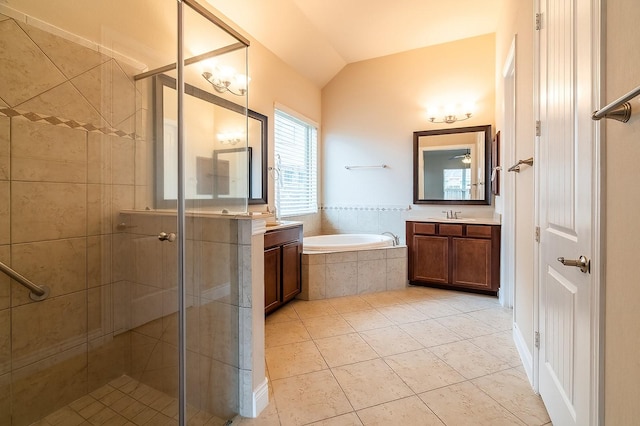 bathroom with tile patterned floors, lofted ceiling, independent shower and bath, and vanity