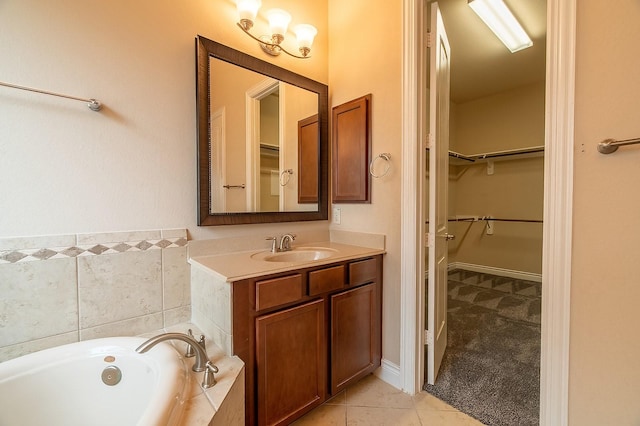 bathroom with vanity, tile patterned floors, and tiled bath