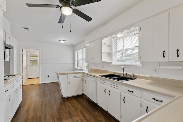 kitchen with sink, dark hardwood / wood-style floors, white dishwasher, kitchen peninsula, and white cabinets