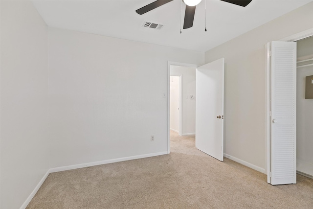 unfurnished bedroom with ceiling fan and light carpet