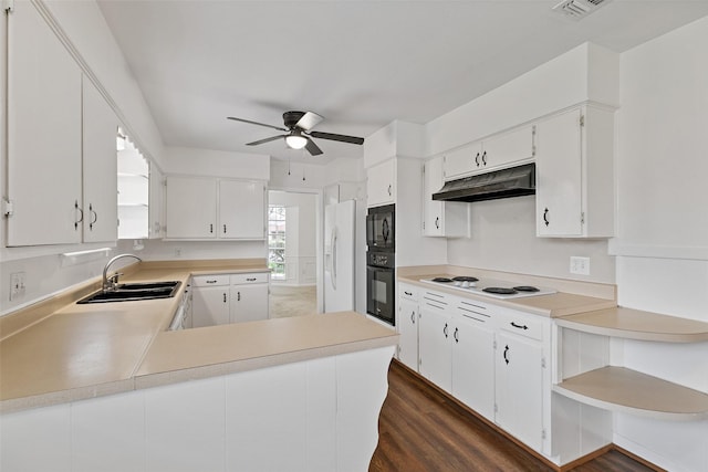 kitchen with sink, white cabinetry, black appliances, dark hardwood / wood-style flooring, and kitchen peninsula