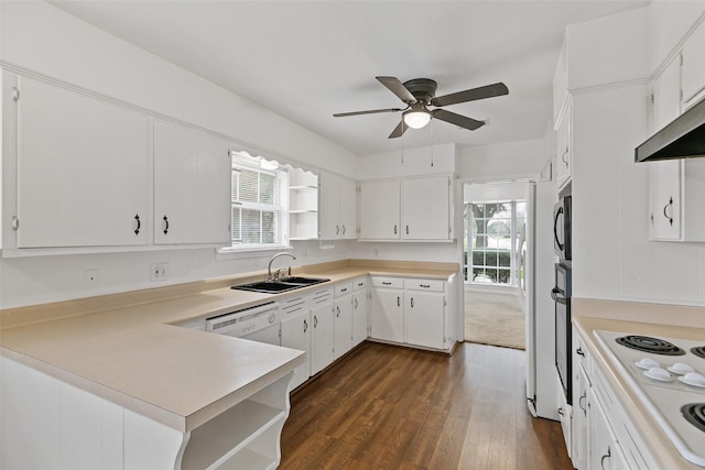 kitchen featuring white cabinetry, sink, dark hardwood / wood-style flooring, kitchen peninsula, and white appliances