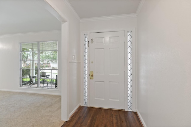 entrance foyer featuring crown molding and dark carpet