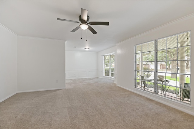 spare room with crown molding, ceiling fan, and light carpet