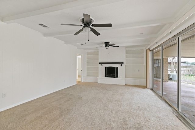 unfurnished living room featuring built in features, ceiling fan, beam ceiling, a fireplace, and light carpet