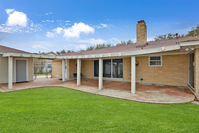 back of house featuring a patio and a yard