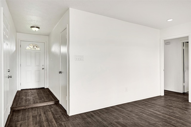 corridor with dark hardwood / wood-style flooring