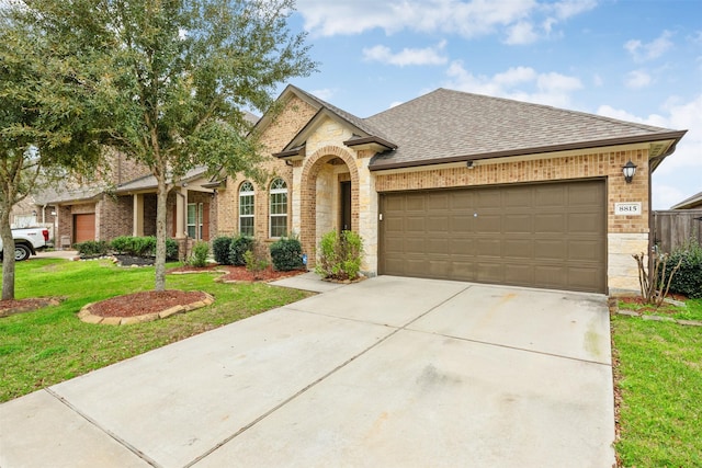 ranch-style home with a garage and a front lawn