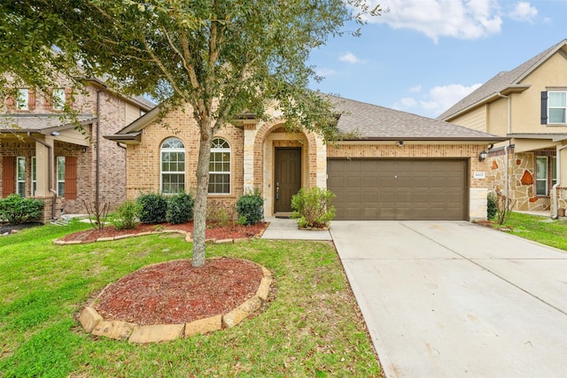 view of front of house with a garage and a front lawn