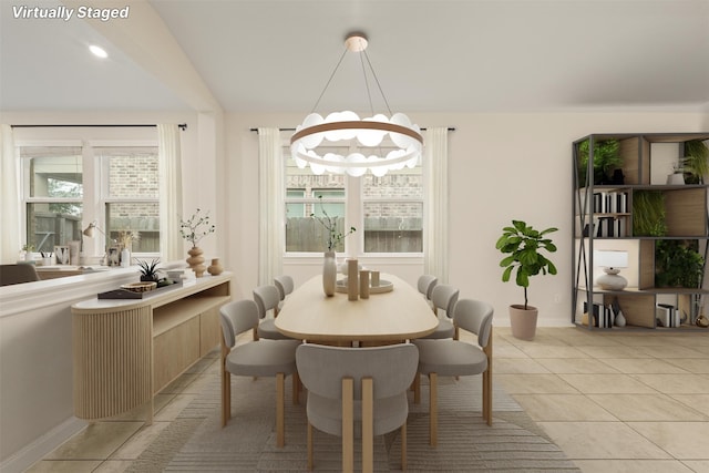 tiled dining room featuring a notable chandelier and plenty of natural light