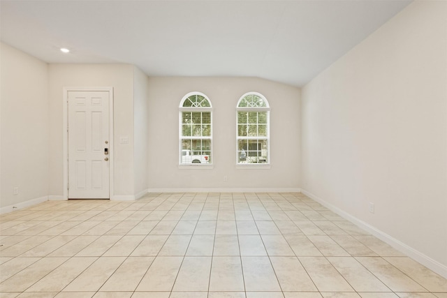 spare room featuring lofted ceiling