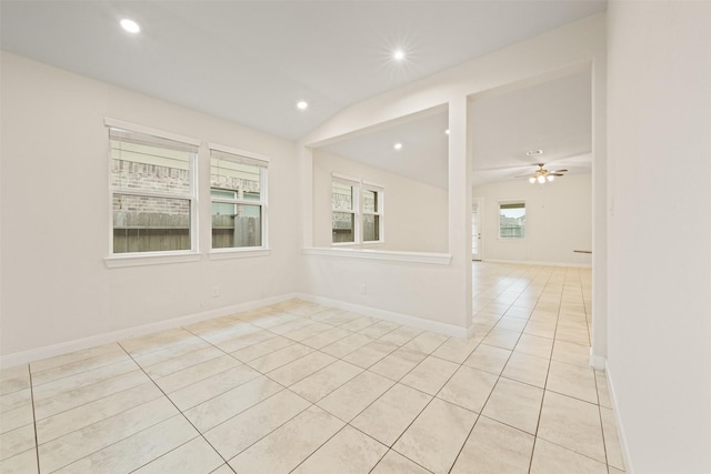 tiled empty room featuring ceiling fan and lofted ceiling