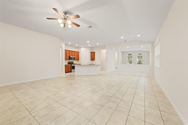 unfurnished living room featuring light tile patterned floors and ceiling fan