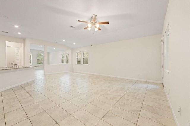 tiled empty room with ceiling fan and sink