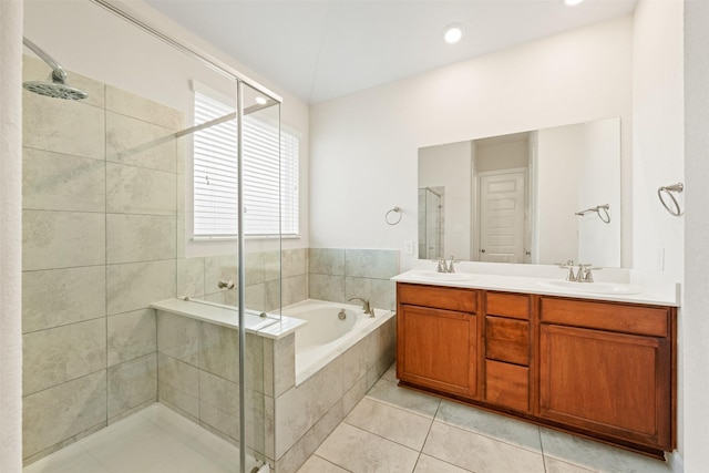 bathroom featuring independent shower and bath, vanity, and tile patterned flooring