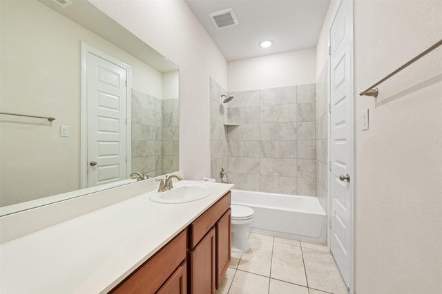 full bathroom with tile patterned flooring, vanity, tiled shower / bath combo, and toilet