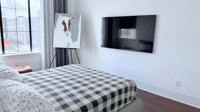 bedroom with dark hardwood / wood-style flooring