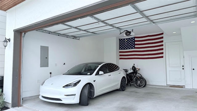 garage with a garage door opener and electric panel