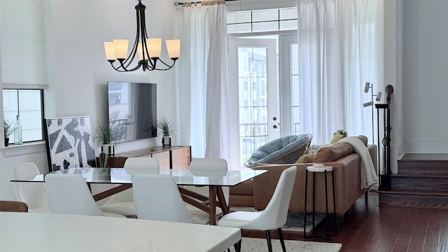 dining area featuring dark hardwood / wood-style floors, a wealth of natural light, and a chandelier