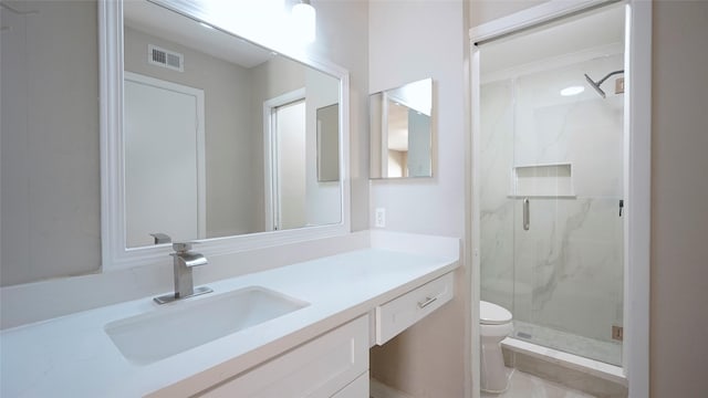 full bathroom featuring visible vents, toilet, vanity, and a marble finish shower