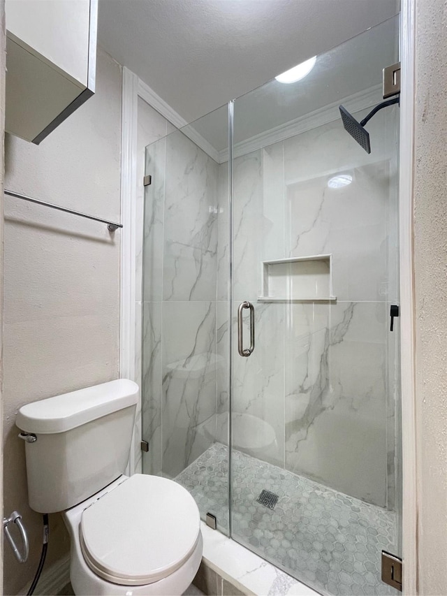 full bathroom featuring ornamental molding, a marble finish shower, and toilet