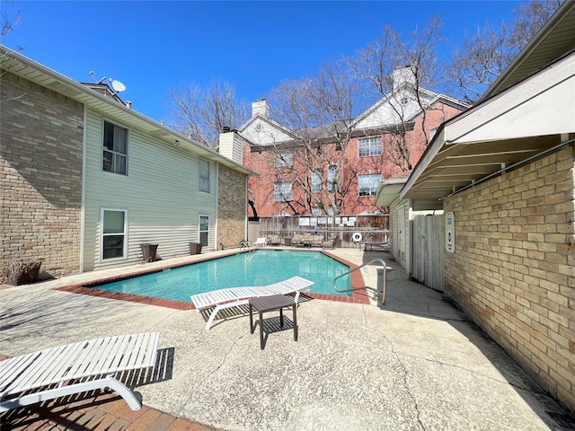 view of pool with a fenced in pool, a fenced backyard, and a patio