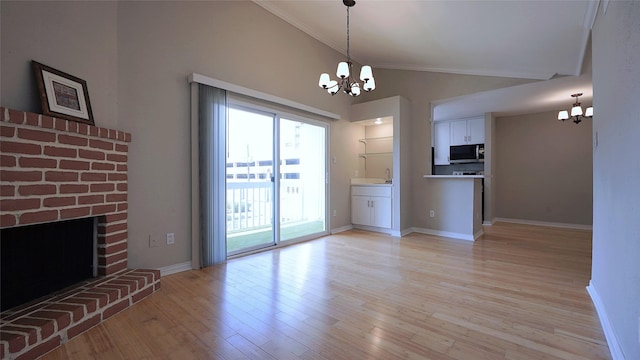2300 Augusta Dr Unit 22, Houston, TX 77057 - unfurnished living room with an inviting chandelier, ornamental molding, lofted ceiling, and light wood-type flooring