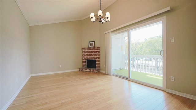 2300 Augusta Dr Unit 22, Houston, TX 77057 - unfurnished living room featuring a brick fireplace, light wood-type flooring, baseboards, a chandelier, and ornamental molding