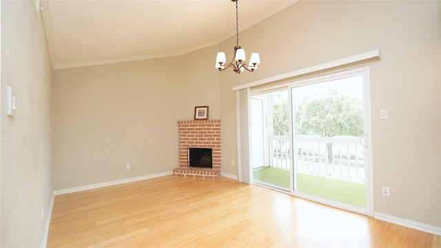2300 Augusta Dr Unit 22, Houston, TX 77057 - unfurnished living room with light wood-type flooring, crown molding, baseboards, a fireplace, and a chandelier