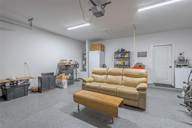 garage featuring freestanding refrigerator, electric water heater, and a garage door opener