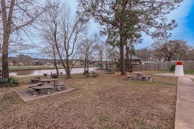 view of yard featuring a water view and fence