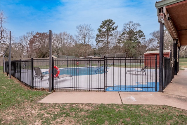 view of pool with a patio area, fence, and a fenced in pool