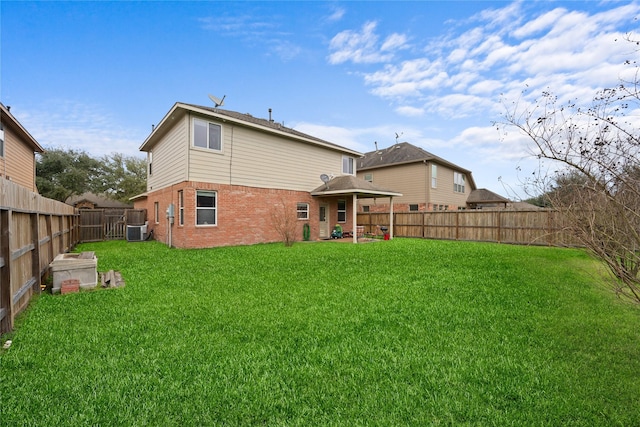 21324 Village Crossing Ln, Porter, TX 77365 - back of property featuring brick siding, central AC, and a patio area