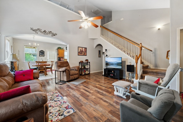 21324 Village Crossing Ln, Porter, TX 77365 - living room featuring arched walkways, high vaulted ceiling, wood finished floors, a chandelier, and stairway