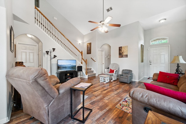 21324 Village Crossing Ln, Porter, TX 77365 - living room with arched walkways, stairway, high vaulted ceiling, a ceiling fan, and wood finished floors
