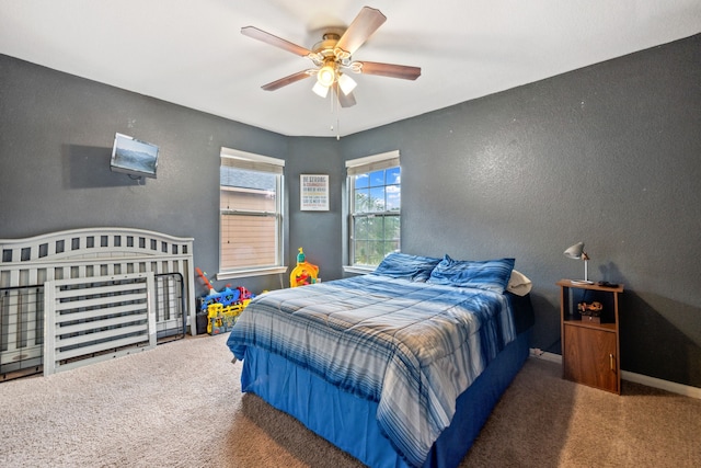21324 Village Crossing Ln, Porter, TX 77365 - bedroom with a textured wall, carpet floors, ceiling fan, and baseboards