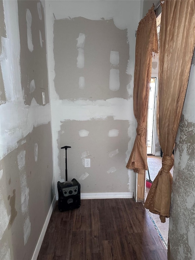 interior space with wood finished floors and baseboards