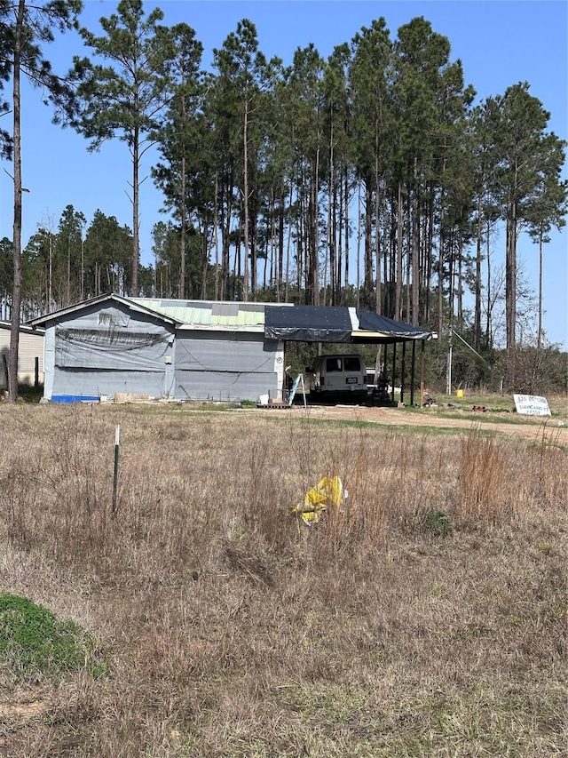 back of property featuring a carport