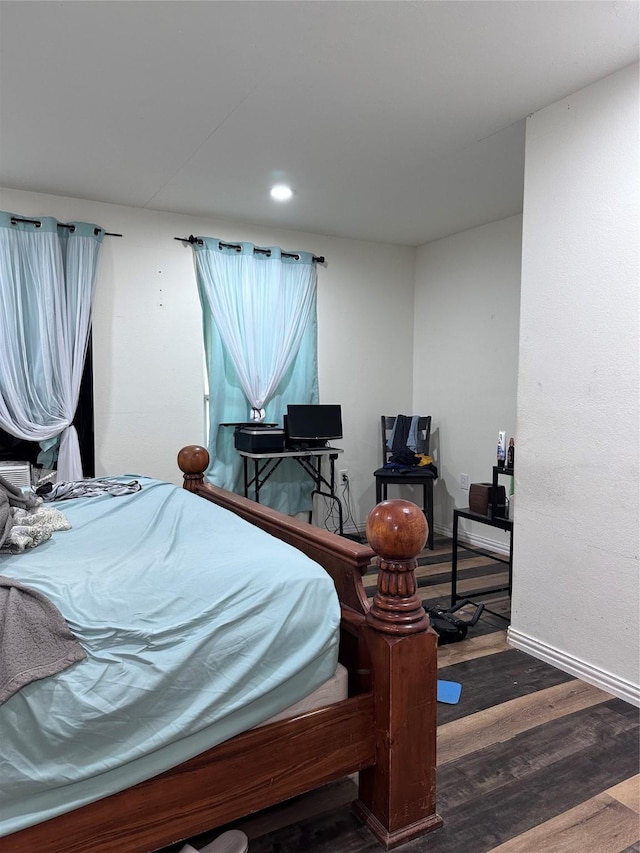 bedroom featuring baseboards and wood finished floors