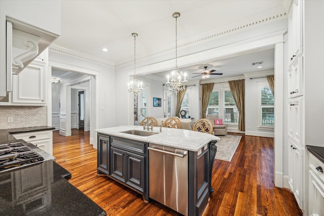 kitchen featuring a center island with sink, dishwasher, white cabinetry, sink, and dark stone counters