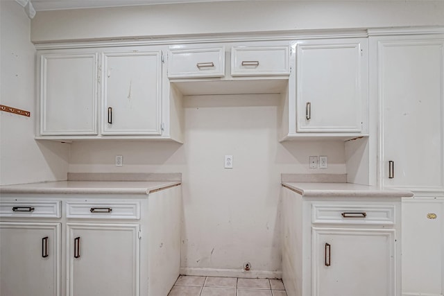 kitchen featuring white cabinets and light tile patterned flooring